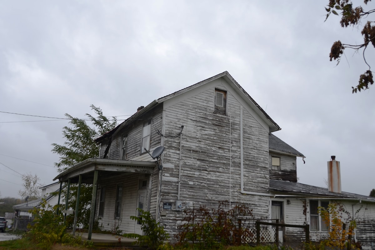 Sub-Performing Note — The Leaky Roof Analogy House needing repair — sub-performing note analogy of fixing a leaky roof to restore value